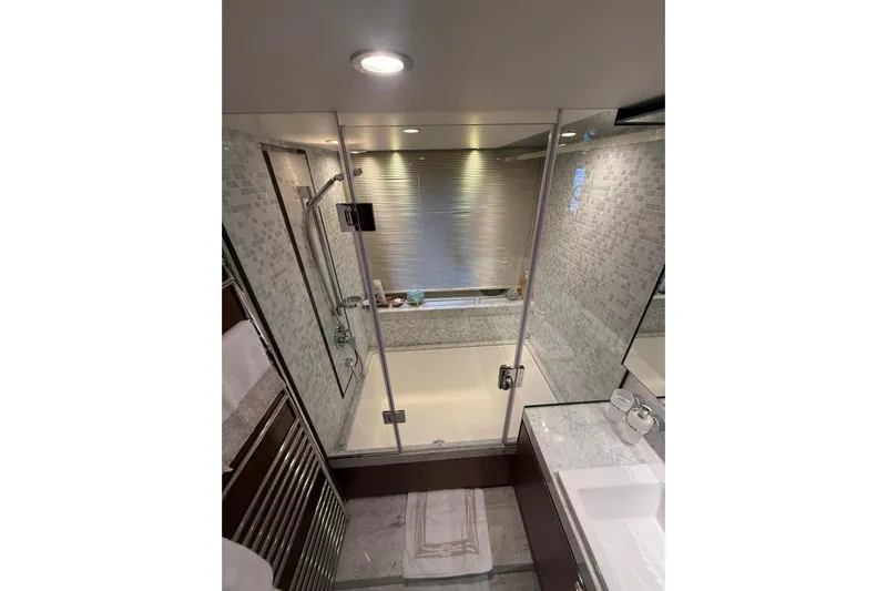  Yacht Photos Pics Luxurious bathroom in 2014 Princess Flybridge 82 Motor Yacht, featuring elegant marble and glass design.