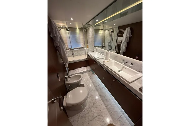  Yacht Photos Pics Luxurious bathroom in 2014 Princess Flybridge 82 Motor Yacht with dual sinks and marble flooring.