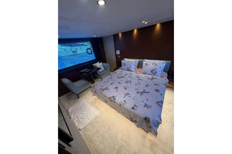 Yacht Photos Pics Luxurious bedroom in 2014 Princess Flybridge 82 Motor Yacht with floral bedding and modern decor.