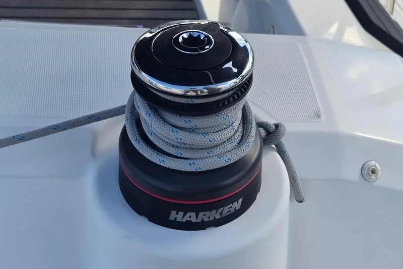 Bluebird Yacht Photos Pics Winch on 2023 Beneteau Oceanis 38.1 sailboat with Harken branding and coiled rope.