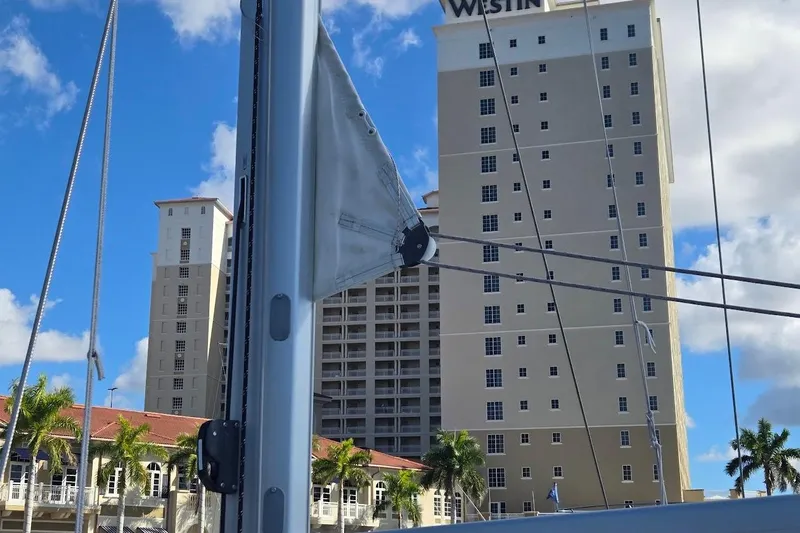 Bluebird Yacht Photos Pics 2023 Beneteau Oceanis 38.1 sailboat mast with cityscape background.