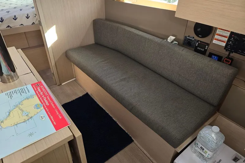 Bluebird Yacht Photos Pics Interior of 2023 Beneteau Oceanis 38.1 yacht with gray sofa and navigation map.