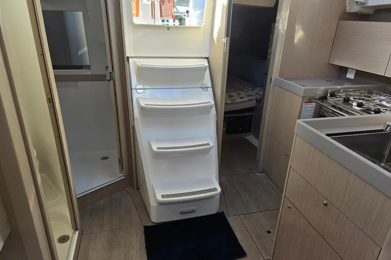 Bluebird Yacht Photos Pics 2023 Beneteau Oceanis 38.1 interior with kitchen, stairs, and cabin view.