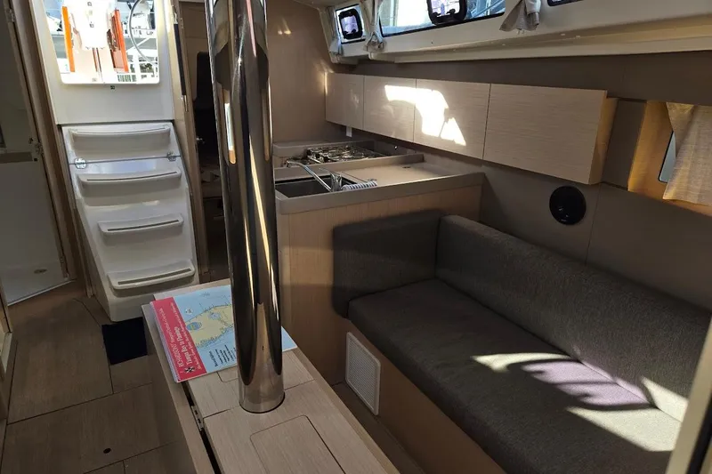 Bluebird Yacht Photos Pics Interior of 2023 Beneteau Oceanis 38.1 yacht, featuring modern kitchen and seating area.