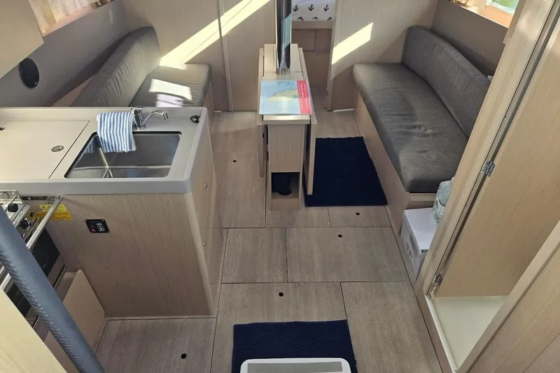 Bluebird Yacht Photos Pics 2023 Beneteau Oceanis 38.1 interior with modern kitchen and seating area.