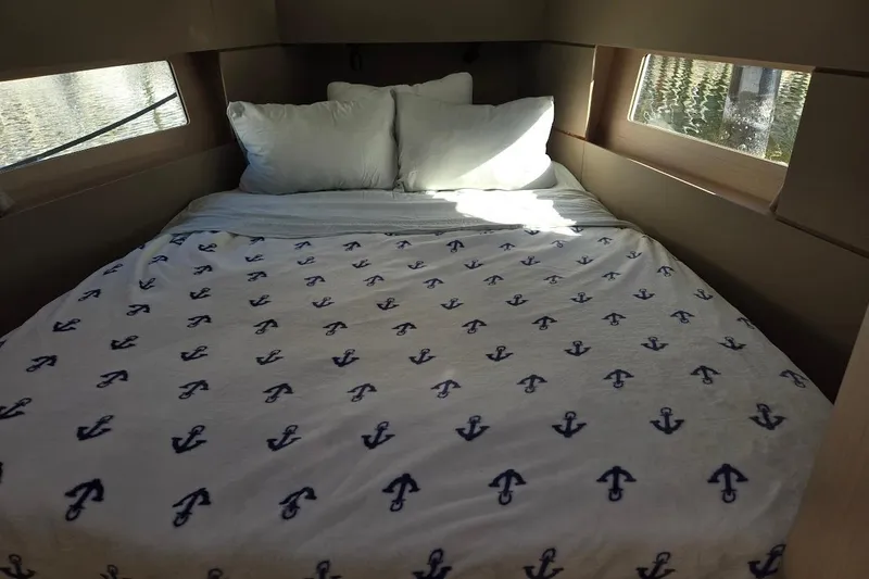 Bluebird Yacht Photos Pics Cozy cabin interior of 2023 Beneteau Oceanis 38.1 with anchor-patterned bedding.