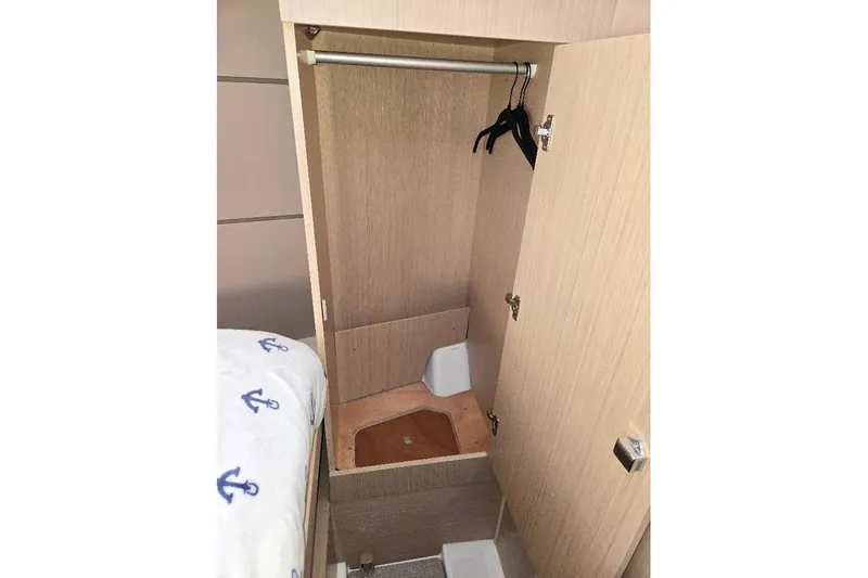Bluebird Yacht Photos Pics 2023 Beneteau Oceanis 38.1 interior closet with hangers and wooden finish.