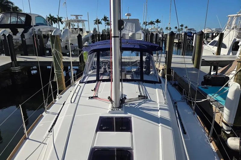 Bluebird Yacht Photos Pics 2023 Beneteau Oceanis 38.1 sailboat docked at marina, clear blue sky.