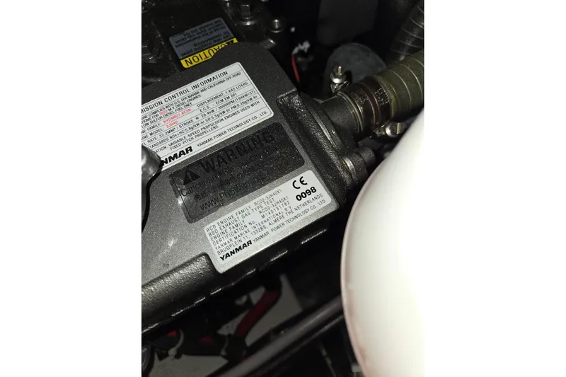 Bluebird Yacht Photos Pics Engine compartment of 2023 Beneteau Oceanis 38.1, featuring Yanmar components and warning labels.