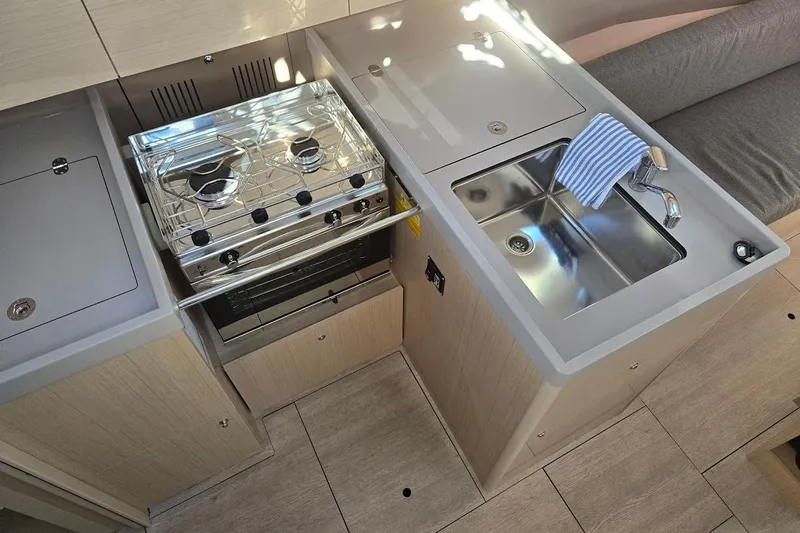 Bluebird Yacht Photos Pics Modern kitchen area in 2023 Beneteau Oceanis 38.1 yacht with stove and sink.