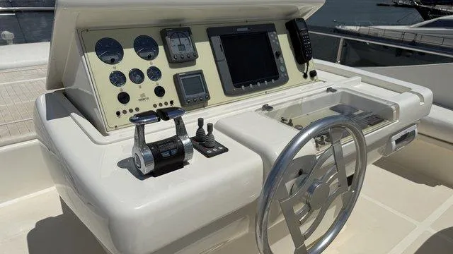 Happy Landing Yacht Photos Pics Control panel of a 2007 Ferretti Yachts 731, featuring gauges and navigation equipment.