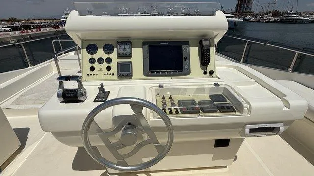 Happy Landing Yacht Photos Pics Control panel of a 2007 Ferretti Yachts 731, featuring navigation instruments and steering wheel.