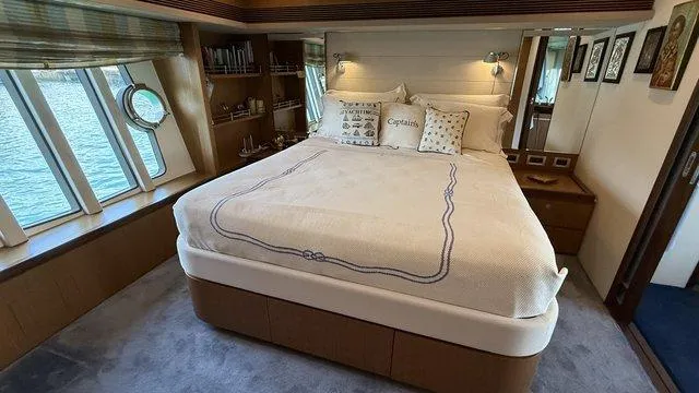 Happy Landing Yacht Photos Pics Luxurious bedroom interior of 2007 Ferretti Yachts 731 with large bed and scenic windows.