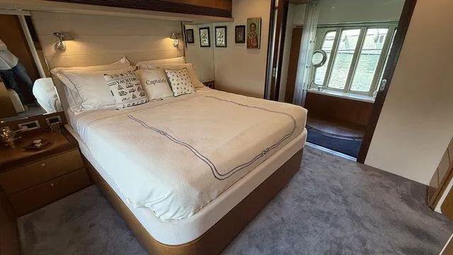 Happy Landing Yacht Photos Pics Luxurious bedroom interior of 2007 Ferretti Yachts 731 with elegant bedding and decor.