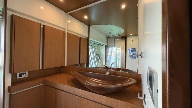 Happy Landing Yacht Photos Pics Luxurious bathroom interior of 2007 Ferretti Yachts 731 with modern sink and wood accents.