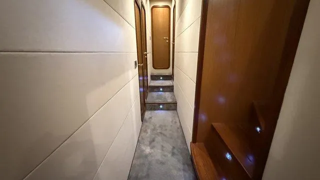 Happy Landing Yacht Photos Pics Hallway inside 2007 Ferretti Yachts 731, featuring elegant wood paneling and soft lighting.
