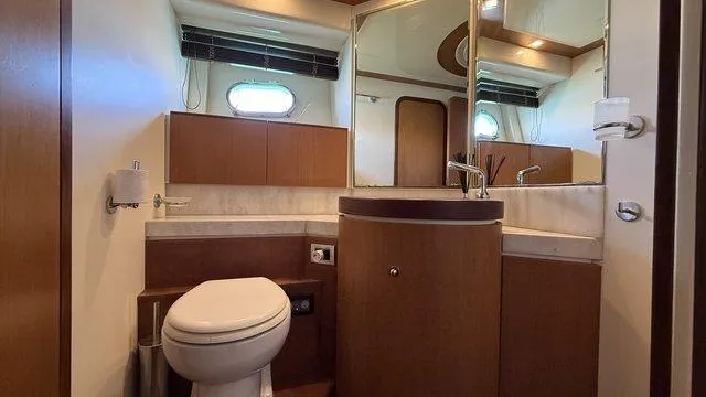 Happy Landing Yacht Photos Pics Luxurious bathroom interior of 2007 Ferretti Yachts 731 with modern fixtures and wood accents.