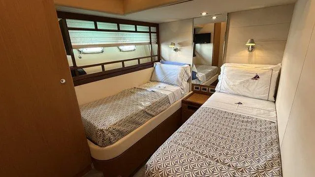 Happy Landing Yacht Photos Pics Luxurious twin bedroom in 2007 Ferretti Yachts 731, featuring elegant bedding and modern lighting.