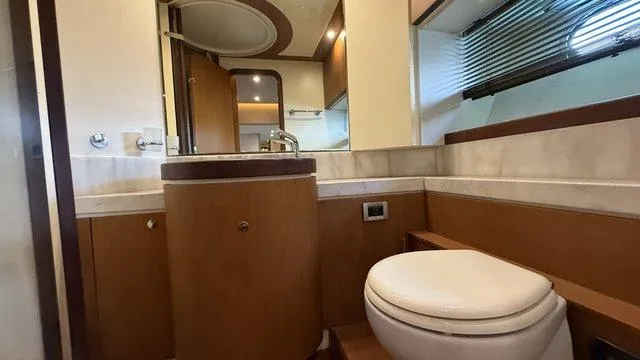 Happy Landing Yacht Photos Pics Luxurious bathroom in 2007 Ferretti Yachts 731, featuring modern fixtures and elegant wood finishes.