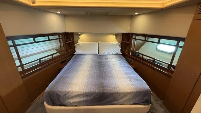 Happy Landing Yacht Photos Pics Luxurious bedroom interior of 2007 Ferretti Yachts 731 with elegant bedding and ambient lighting.