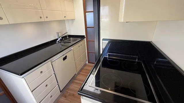 Happy Landing Yacht Photos Pics Modern kitchen in a 2007 Ferretti Yachts 731, featuring sleek countertops and appliances.