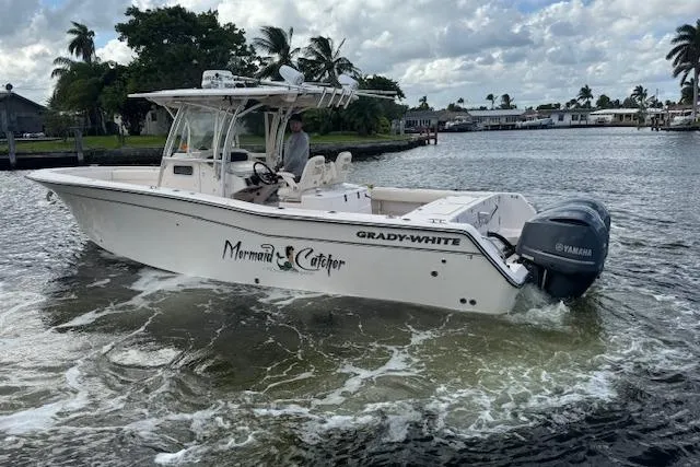  Yacht Photos Pics 2007 Grady-White Bimini 306 boat cruising on a calm waterway.