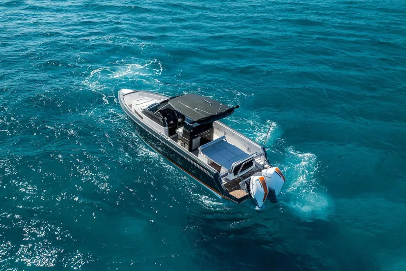  Yacht Photos Pics 2024 Schaefer V33 boat cruising on clear blue ocean waters.