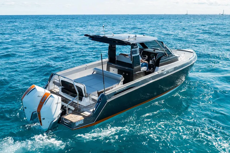  Yacht Photos Pics 2024 Schaefer V33 boat cruising on open blue sea, featuring dual outboard engines.