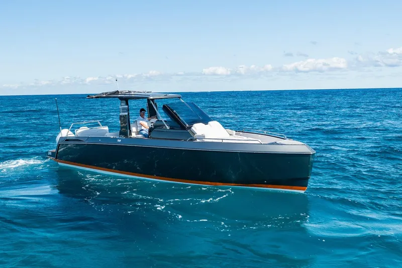  Yacht Photos Pics 2024 Schaefer V33 boat cruising on open blue ocean under clear sky.