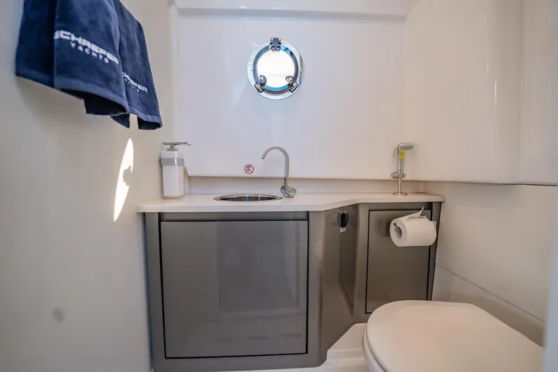  Yacht Photos Pics 2024 Schaefer V33 yacht bathroom with sink, toilet, and porthole window.