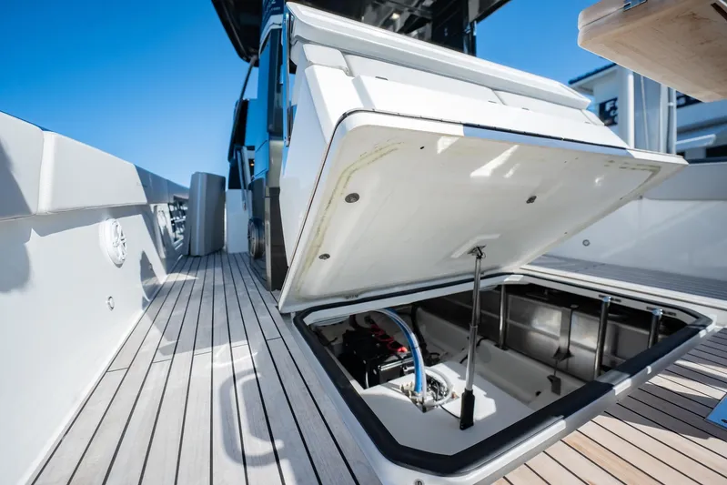  Yacht Photos Pics 2024 Schaefer V33 yacht deck with open storage compartment, showcasing modern design.