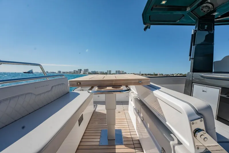  Yacht Photos Pics 2024 Schaefer V33 yacht interior with seating and table, ocean view in background.