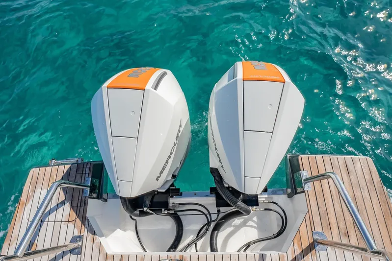  Yacht Photos Pics Twin Mercury outboard engines on 2024 Schaefer V33 yacht, turquoise water background.