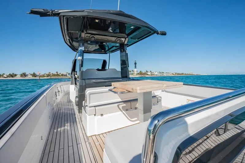  Yacht Photos Pics 2024 Schaefer V33 boat on clear blue water, featuring sleek deck and seating area.