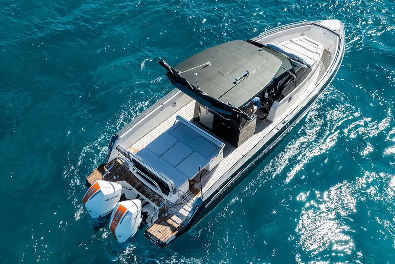  Yacht Photos Pics Aerial view of 2024 Schaefer V33 boat cruising on clear blue water.