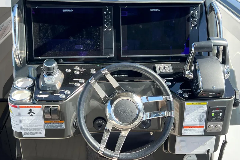  Yacht Photos Pics 2024 Schaefer V33 boat dashboard with steering wheel and dual Simrad displays.