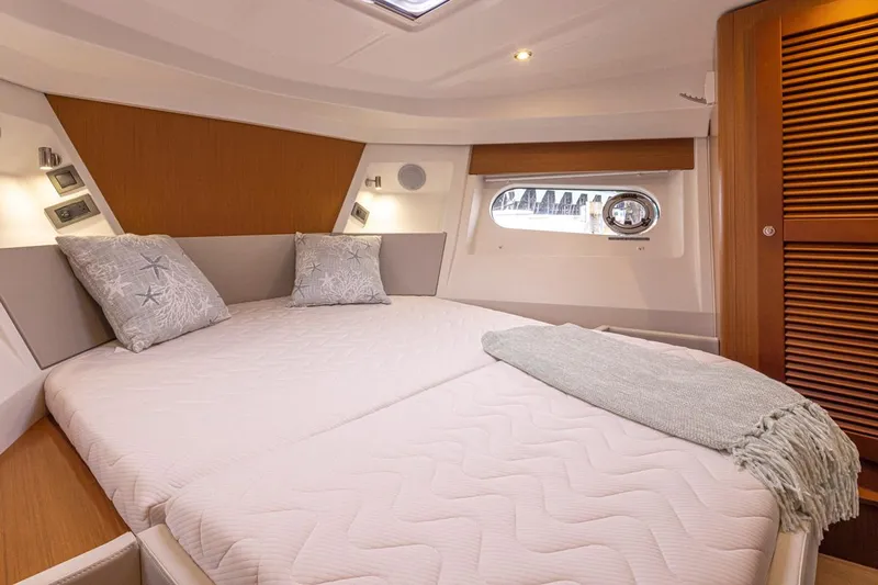 Cheers Yacht Photos Pics Luxurious cabin interior of 2019 Beneteau Swift Trawler 35 with cozy bedding and elegant design.