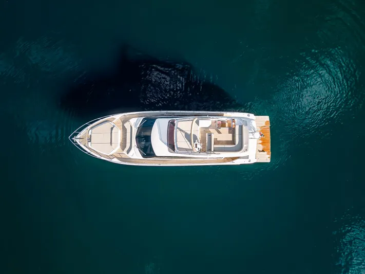 La Seduction Yacht Photos Pics Aerial view of 2022 Ferretti Yachts 550 on calm blue water.