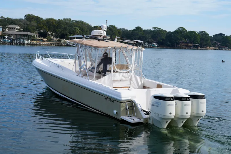  Yacht Photos Pics 1999 Intrepid 366 boat with triple Suzuki engines on a calm lake.