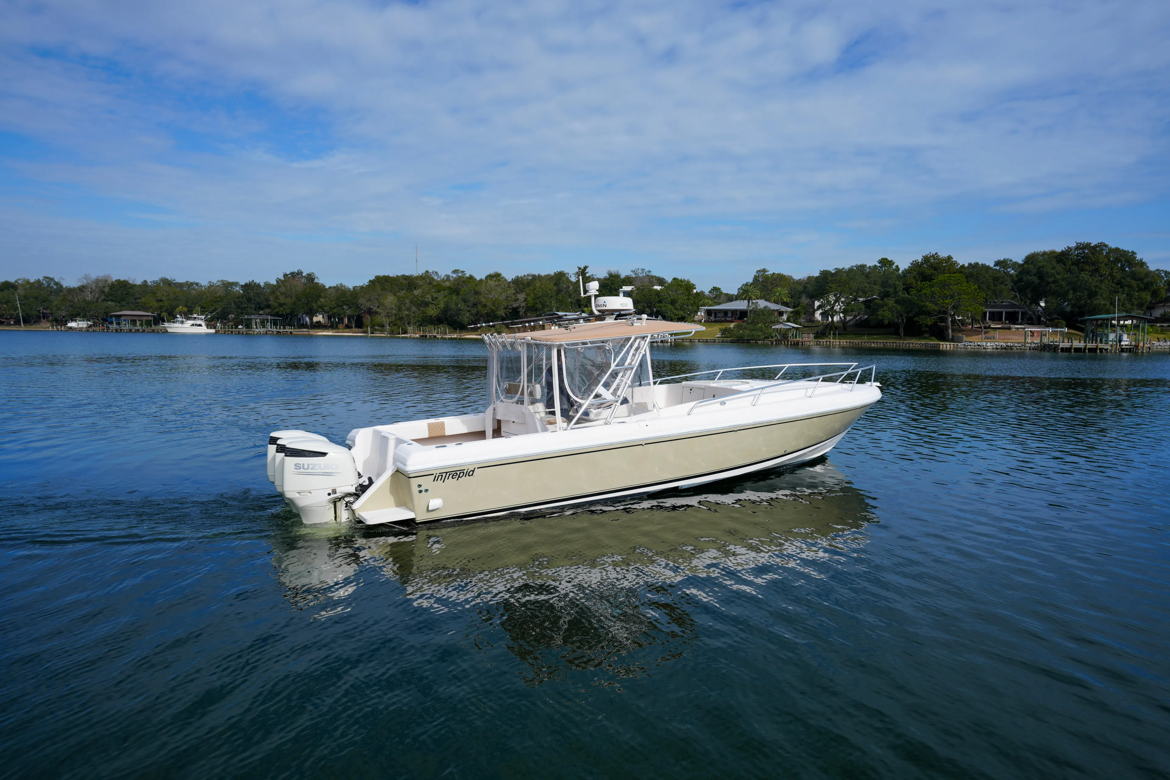  Yacht Photos Pics 1999 Intrepid 366 boat on calm water, clear sky, surrounded by trees.