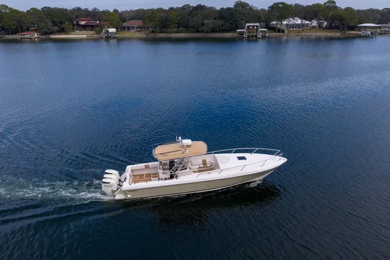  Yacht Photos Pics 1999 Intrepid 366 boat cruising on a serene lake with scenic shoreline.