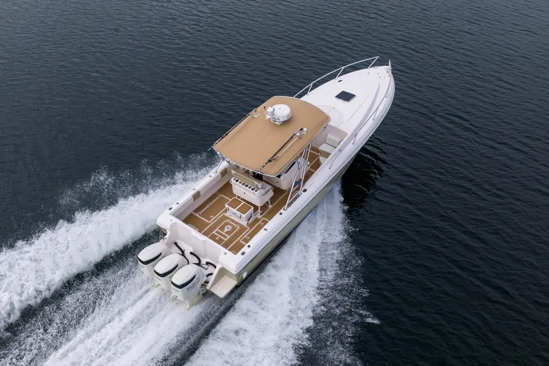  Yacht Photos Pics 1999 Intrepid 366 boat cruising on open water, aerial view.