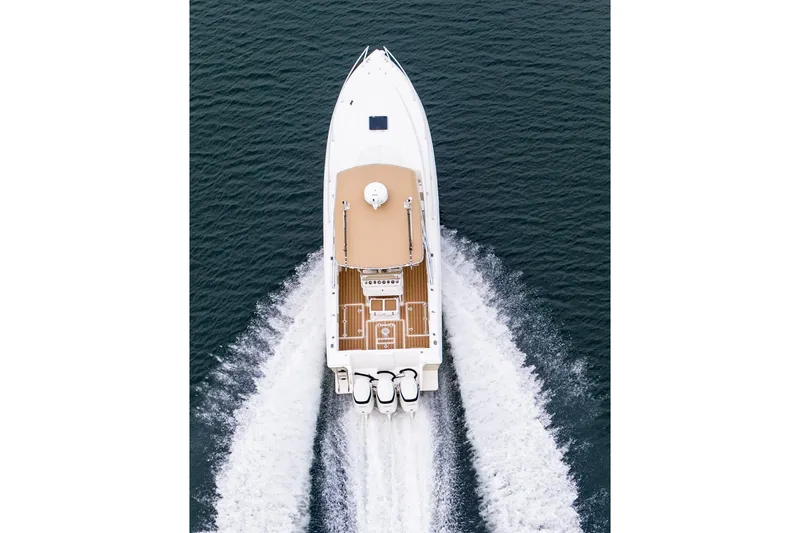  Yacht Photos Pics Aerial view of 1999 Intrepid 366 boat cruising on open water.