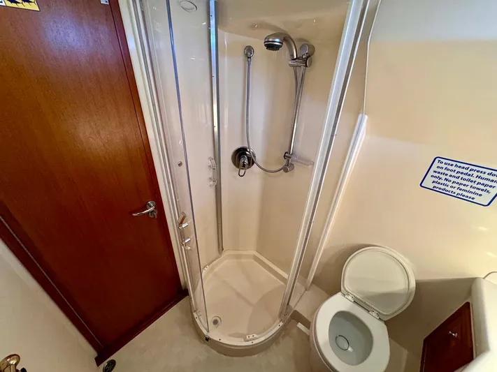 Bill Slayer Yacht Photos Pics Bathroom interior of 2002 Cabo 47 Flybridge Sportfisher with shower and toilet.