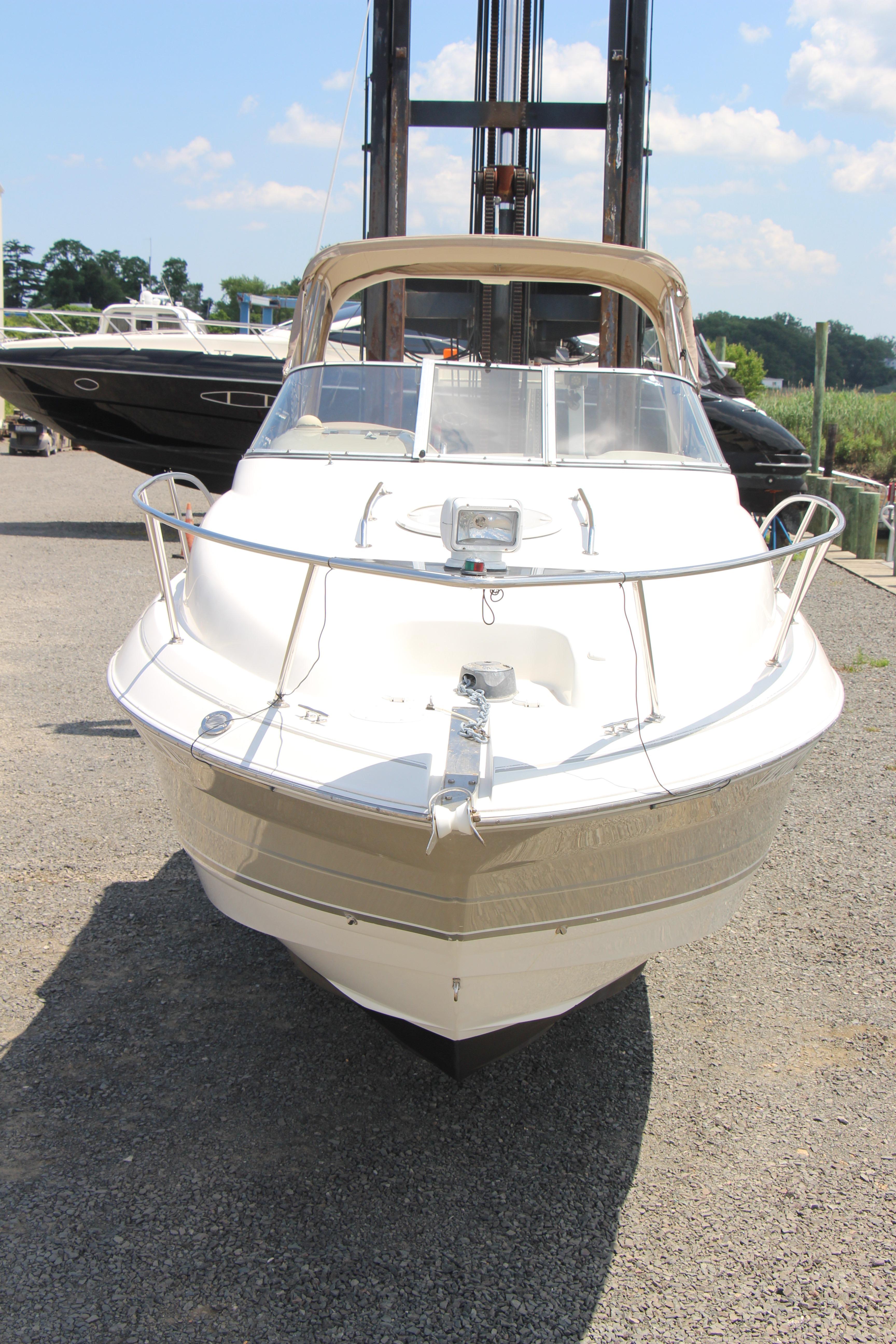 2008 Larson Cabrio 260 boat on dry dock under sunny skies.