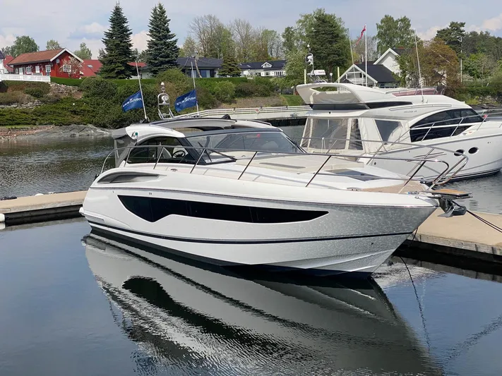 V40157 Yacht Photos Pics 2023 Princess V40 yacht docked in a serene marina setting.