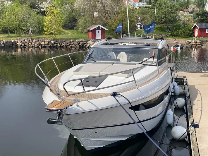 V40157 Yacht Photos Pics Luxury 2023 Princess V40 yacht docked in a serene marina setting.