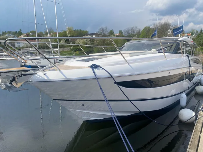 V40157 Yacht Photos Pics 2023 Princess V40 yacht docked at marina, sleek design, calm water, overcast sky.