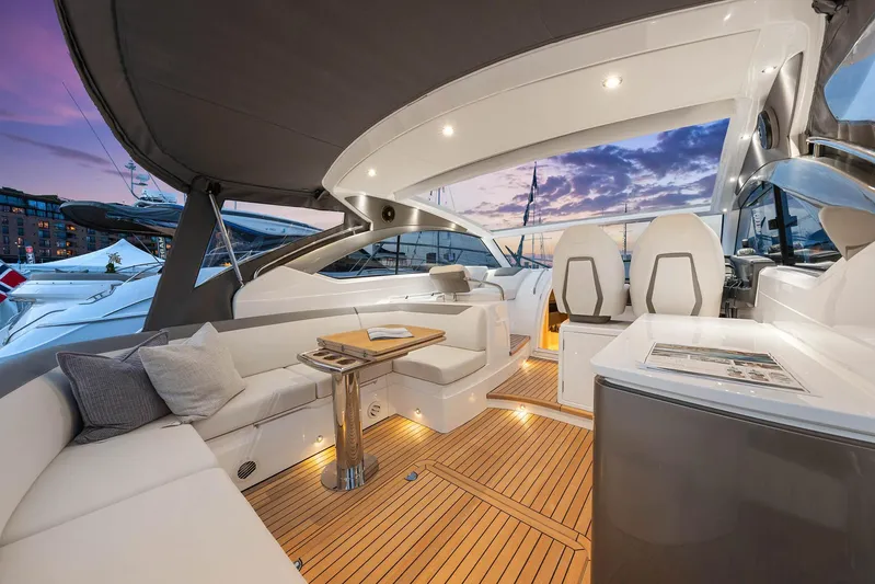 V40157 Yacht Photos Pics Luxurious 2023 Princess V40 yacht interior with elegant seating and ambient lighting at sunset.