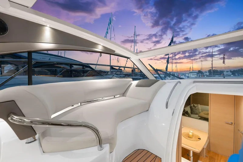 V40157 Yacht Photos Pics Luxurious 2023 Princess V40 yacht interior with sunset view and elegant seating area.